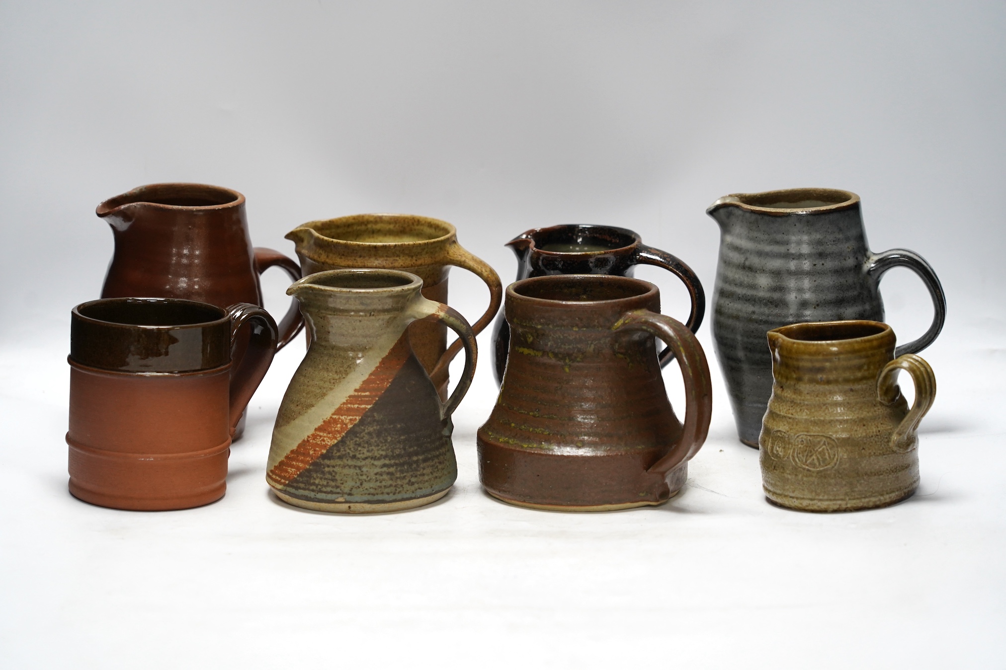 Nine pottery jugs, makes include Arabia of Finland, David Birch of Fulham etc, tallest 17cm high. Condition - fair to good